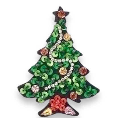 A festive Christmas tree-shaped pin adorned with rhinestones and sequins in various colors such as green, red, and silver.