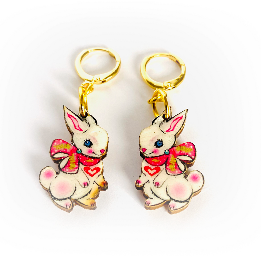 <p>'' Cute Easter rabbit drop earrings featuring Layla the magical little baby Bunny. Beautifully illustrated and incredibly comfy to wear. Brighten up your easter with these special pieces of unusual jewellery. Earrings basics * Measurement 6cm x 6xm * Bunny theme * Miss matched colours * Resin on woods creating a glass affect * Gold plated comfy huggie hoops * </p> <p>Layla the bunny huggie hoop earrings</p>