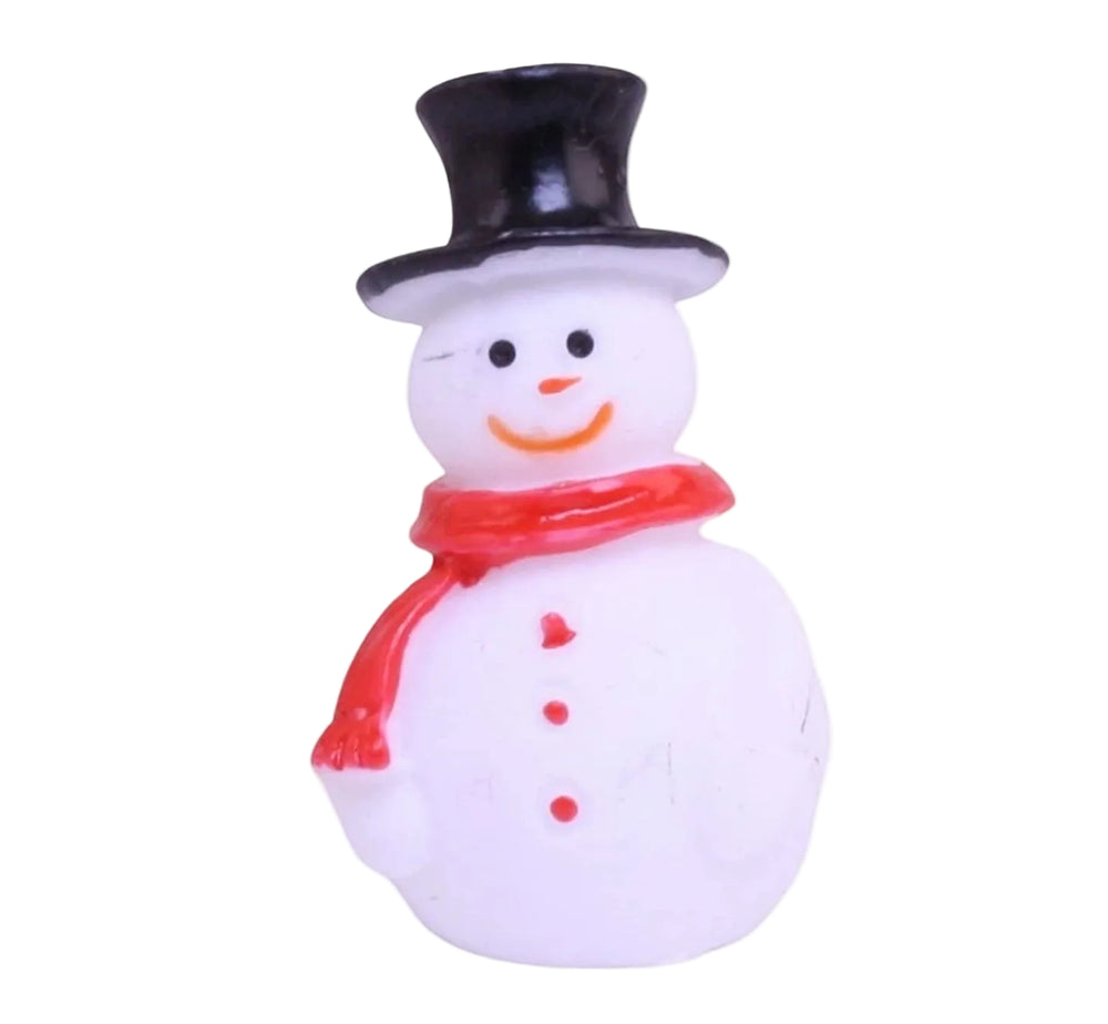 Small snowman figurine with a black top hat and red scarf on a white background