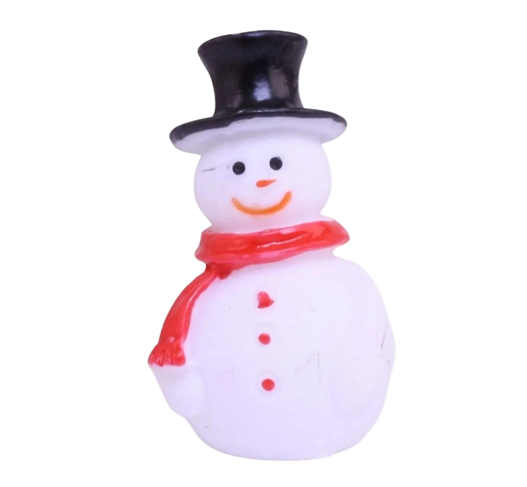 Small snowman figurine with a black top hat and red scarf on a white background