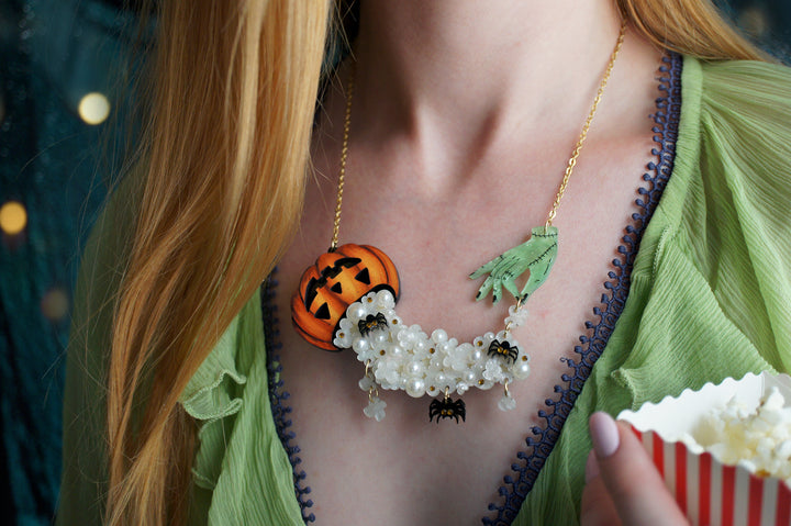 Zombie hand popcorn necklace worn — articulated acrylic horror jewelry — LaliBlue Midnight Cinema