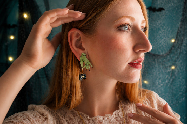 Zombie hands and spider earrings close-up — acrylic horror statement jewelry — LaliBlue Midnight Cinema