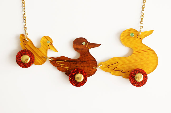 Ducks on wheels necklace side view, LaliBlue Christmas jewelry, vintage toy