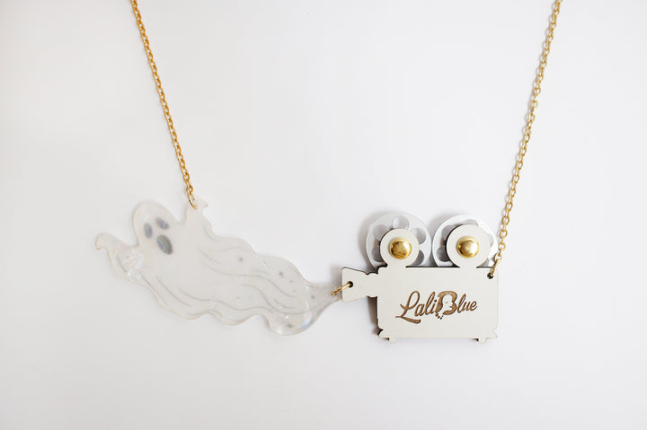 Ghost film projector necklace angle view — articulated Halloween cinema acrylic jewelry — LaliBlue Midnight Cinema
