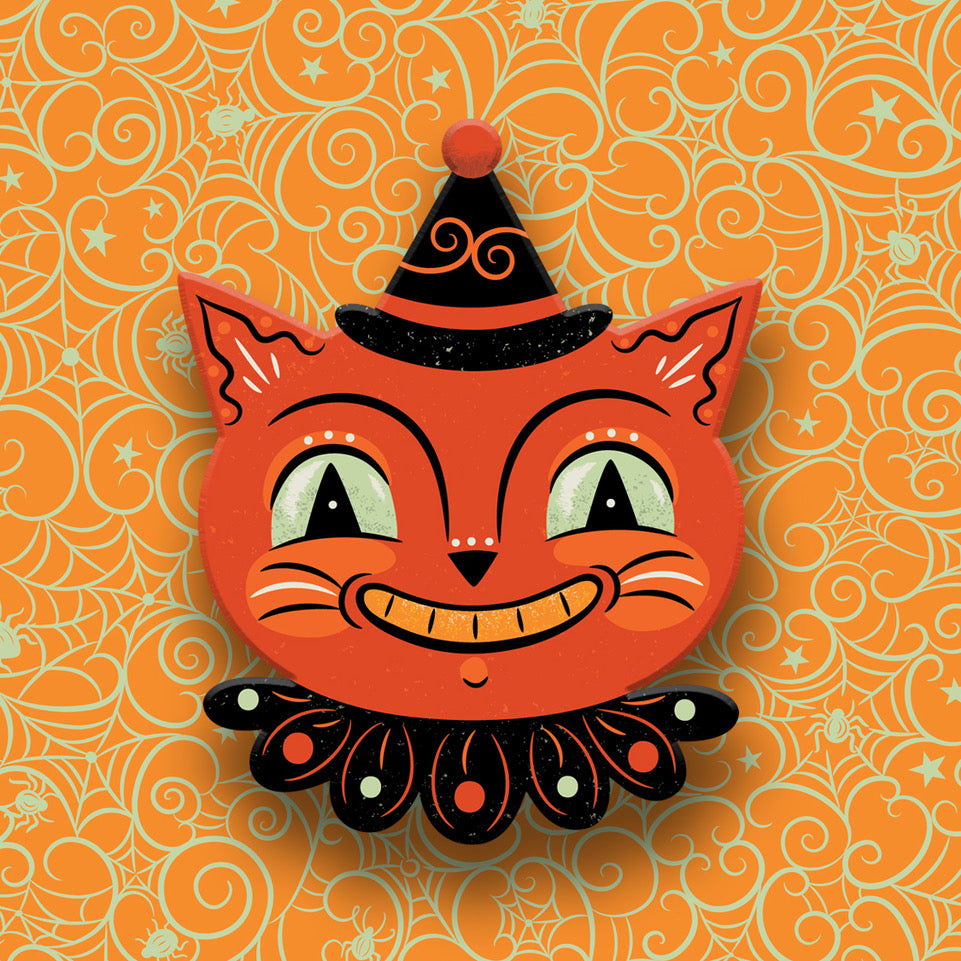 Halloween-themed cat face decoration with a witch hat on an orange patterned background Johanna Parker cat halloween