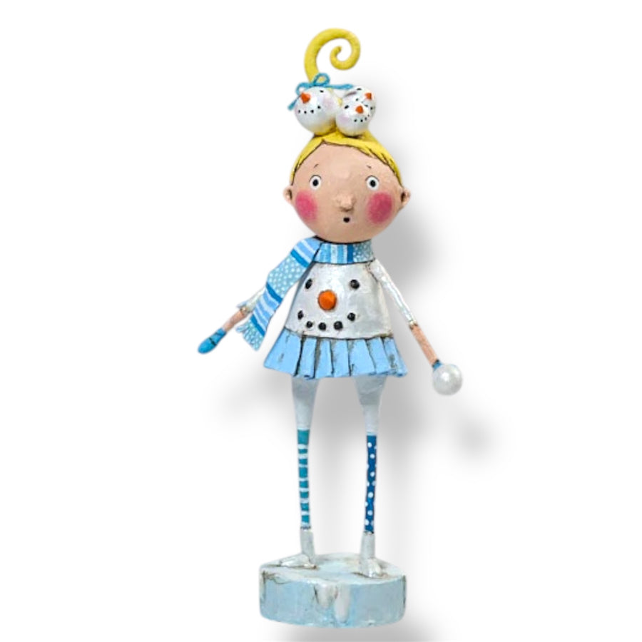 A whimsical Christmas figurine featuring a character with a blue and white outfit, holding a snowball, and wearing a yellow hat with a bell on top.