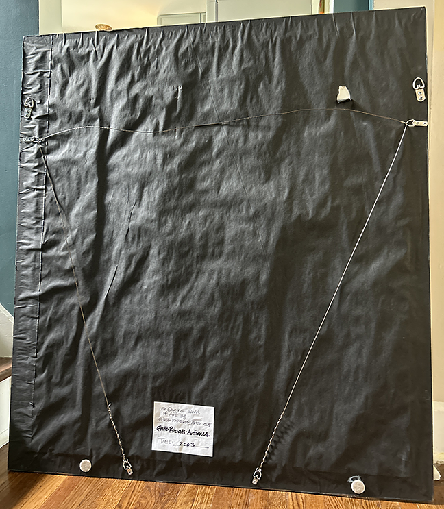 Back of the framed Chris Roberts-Antieau artwork with black dust cover, hanging wire, and artist label