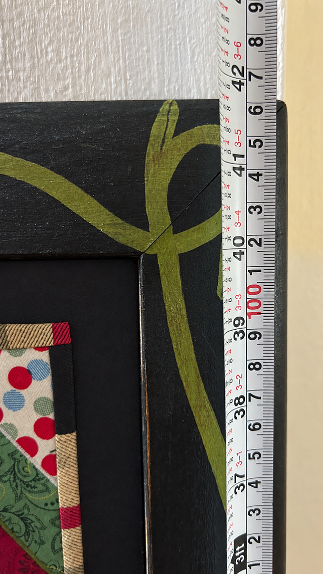 Tape measure showing Chris Roberts-Antieau Ten Table Manners framed height of about 42 inches