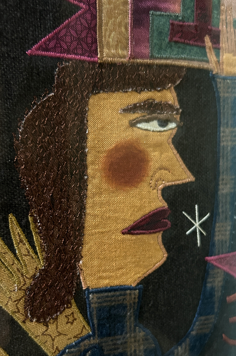 Close-up of a thread-painted figure's face in profile with embroidered hair and red lips, Chris Roberts-Antieau fabric art