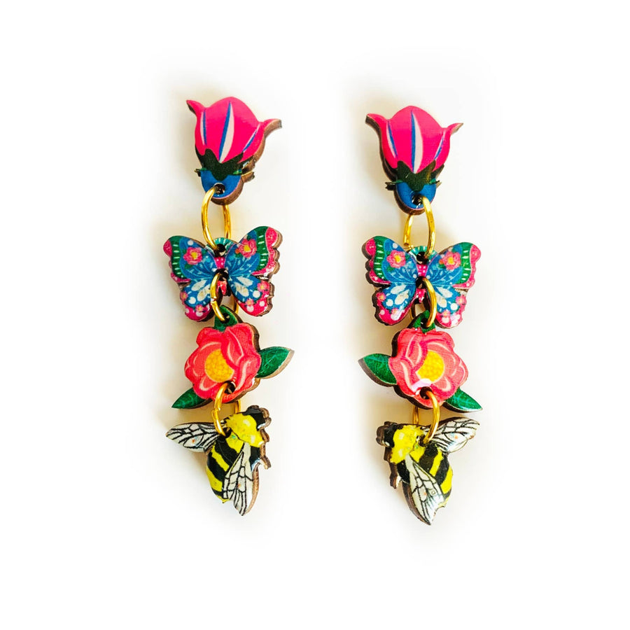 'Floral heaven dangle butterfly earrings' Elevate your summer wardrobe with these absolutely beautiful dangle floral earrings! including tulips, a flower a bee and a pretty floral butterfly. Each component illustrated inhouse. These are such a joy to wear. Hypoallergenic and perfect for day wear and your summer spring outfits. These are our favourite pieces for summer! Earring basics * Measurement - 5cm drop length... but not too long to be annoying. each component is 1cm. * Handmade and illustraed inhouse.