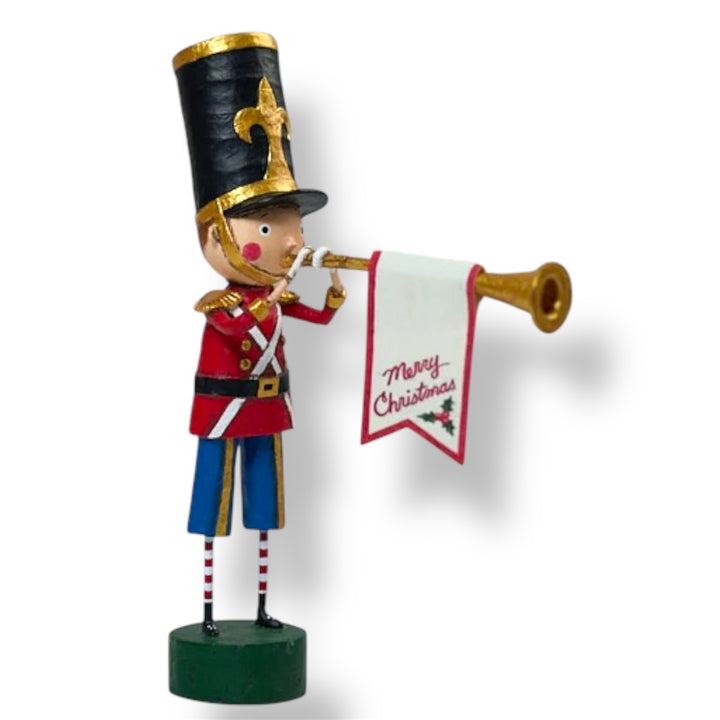 A Christmas figurine of a toy soldier in red and blue uniform, playing a golden horn, with a 'Merry Christmas' banner.