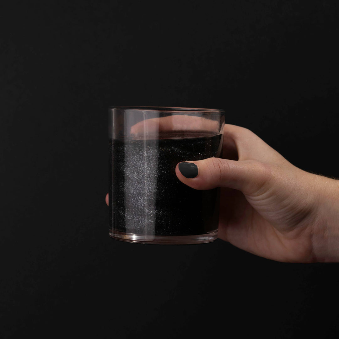 Elevate your spooky soirée with Black Cotton Candy Drink Glitter Bombs. These hand-spun champagne-flavored cotton candy puffs sparkle with edible black glitter. Drop one into your favorite clear, bubbly drink and watch it dissolve, turning your beverage into a magical, shimmering treat with a hint of sweetness. Each pack contains 4 glitter bombs—perfect for adding eerie elegance to any haunted gathering. Rip, drop, pour, and sip the sparkle!