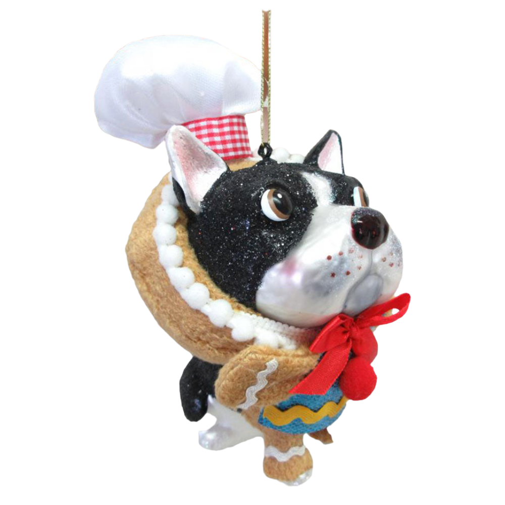Dog-shaped ornament wearing a chef's hat and apron on a white background
