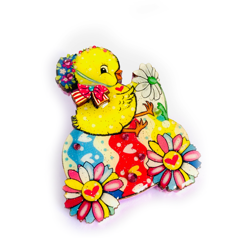 'Chickadee goes riding Brooch' A very sweet chickadee brooch with Mr chic riding a little egg wih ester flowers as wheels! Beep Beep! Brooch basics * measurements 6cm x 6cm * Certified woods/lasercut. * Stainless steel brooch back * Illustrated inhouse. * Resin cured. * Pastel acylics. * Perfect for spring. * Bunny theme.. great easter gift!
