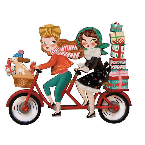 Two women riding a tandem bicycle with Christmas gifts on a white background