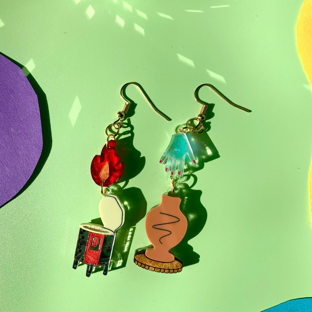 Colorful earrings on a green background with disco ball