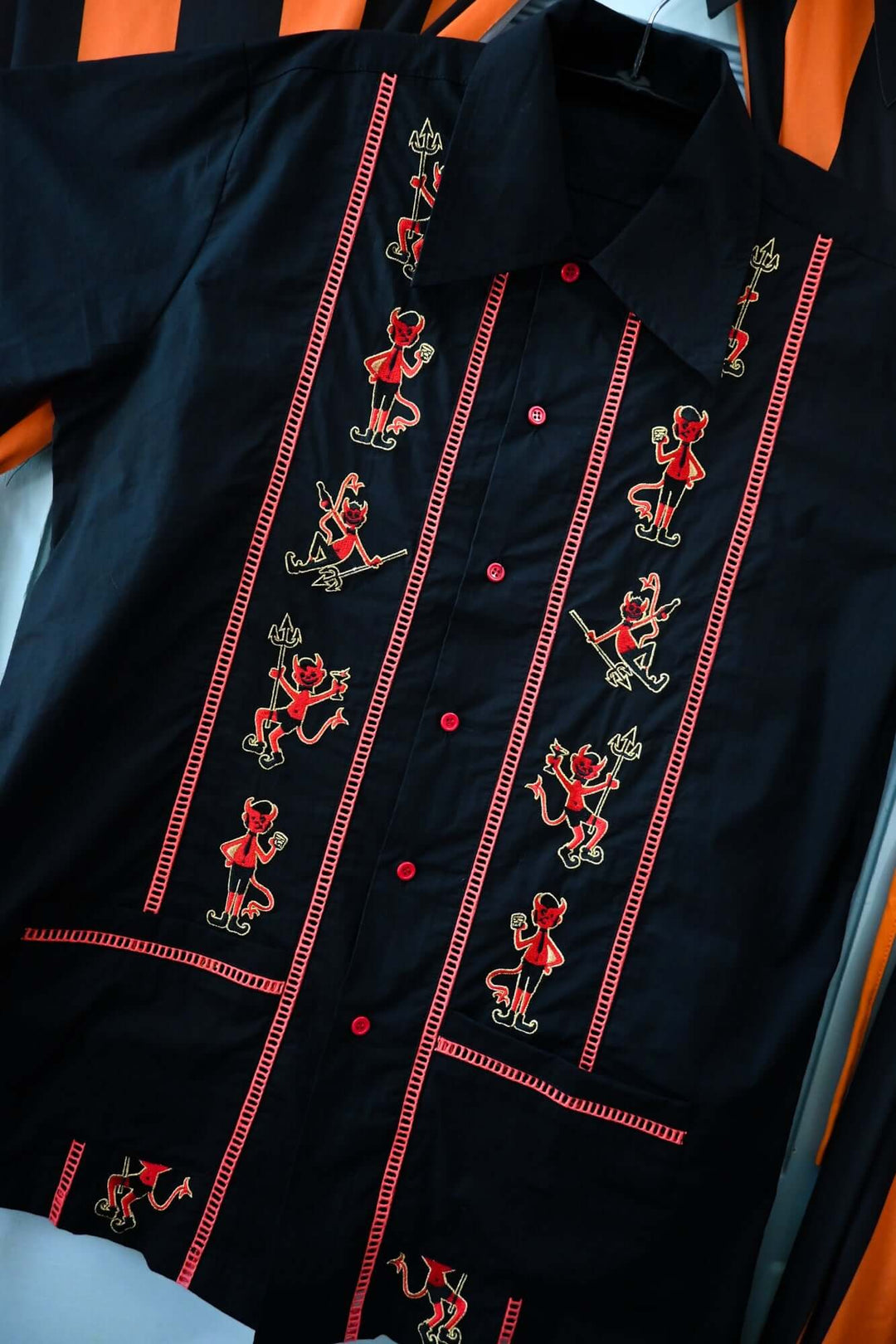 Black shirt with red embroidery of devils