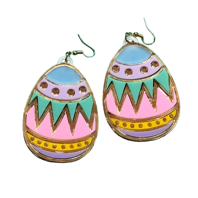 A collection of colorful Easter egg acrylic earrings displayed on a teal background. The earrings are designed to resemble Easter eggs with geometric patterns and rhinestone accents.