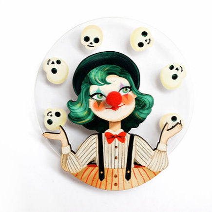 Clown figurine with green hair and a red nose on a white background