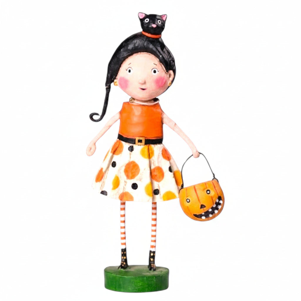 Halloween-themed figurine of a girl with black hair, orange dress, and pumpkin bucket  kit kat lori mitchell halloween