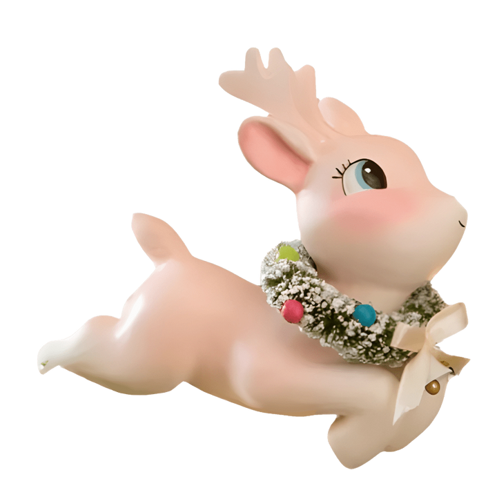 leaping reindeer figure with a wreath on a pink reindeer pinkmas bethany lowe