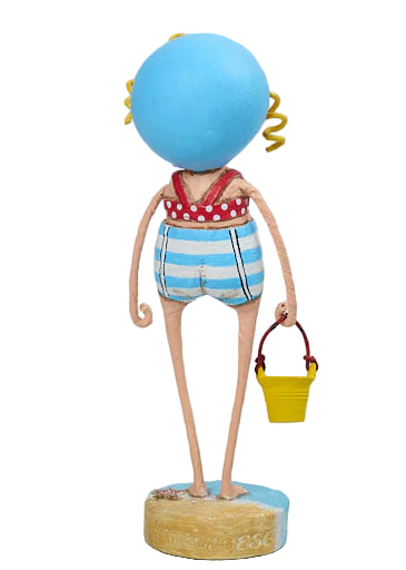 lori mitchell sandy girl Figurine with a blue head, red and white polka dot top, striped shorts, and holding a yellow bucket