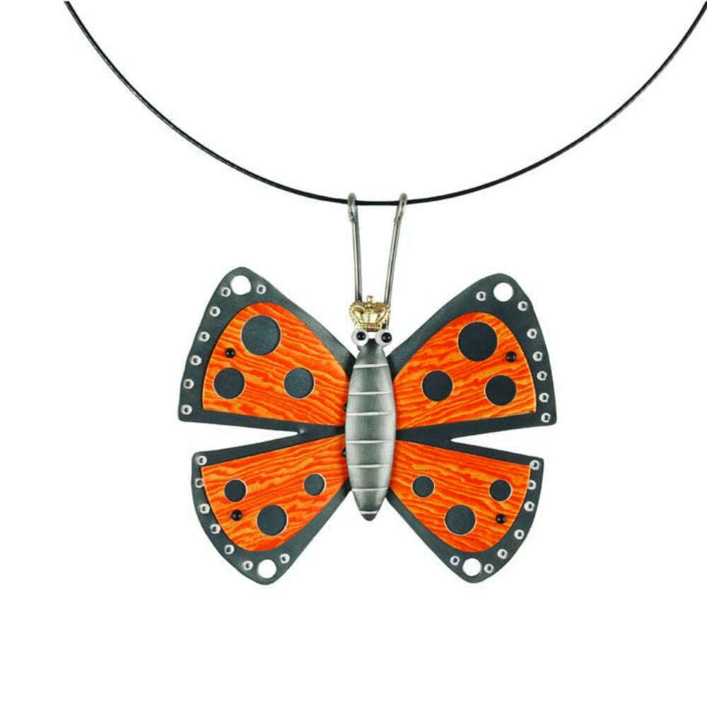 Chickenscratch Monarch Butterfly Necklace — handmade orange wood-grain guitar pick butterfly pendant with blackened wings and white accents on 18-inch cable necklace