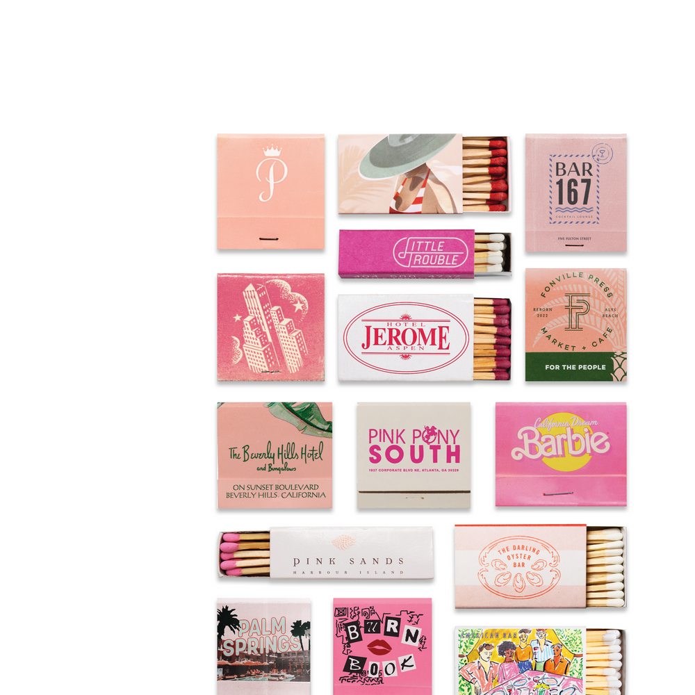 Collection of pink matchboxes with various designs and text on a white background
