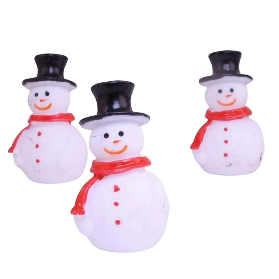 Three small snowman figurines with black top hats and red scarves 