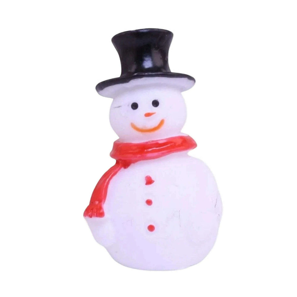Small snowman figurine with a black top hat and red scarf on a white background