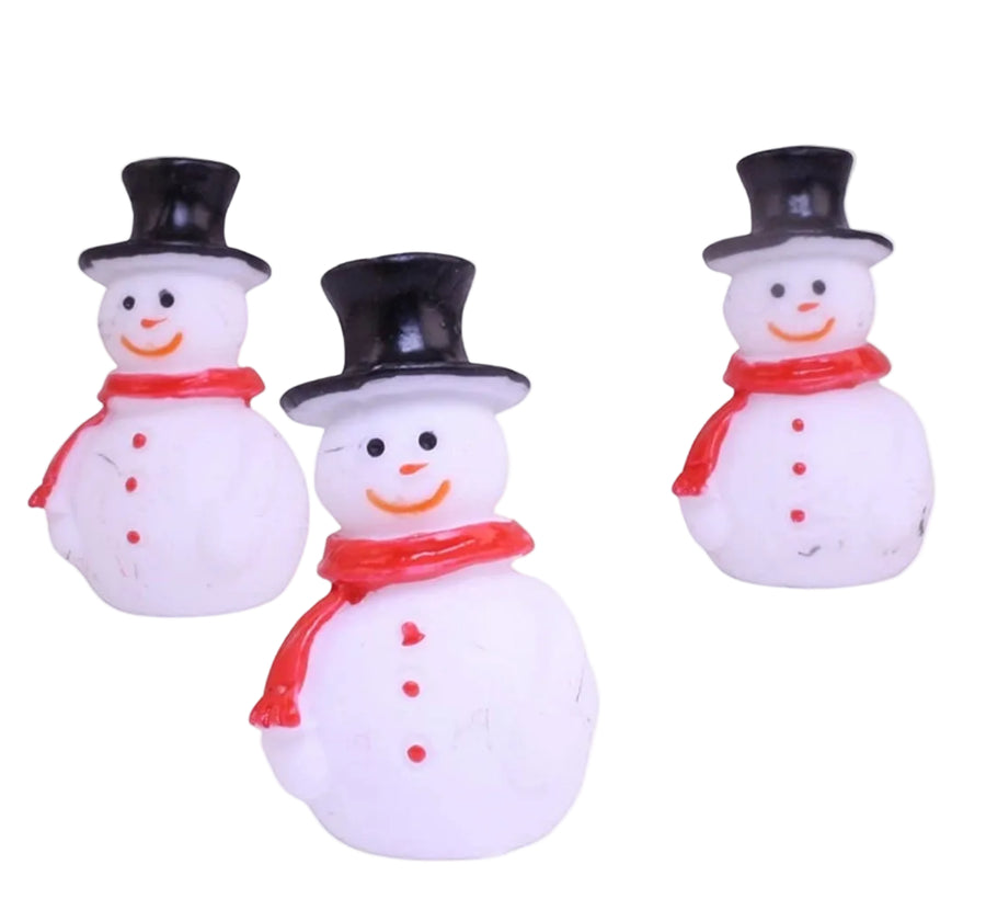 Three small snowman figurines with black top hats and red scarves 